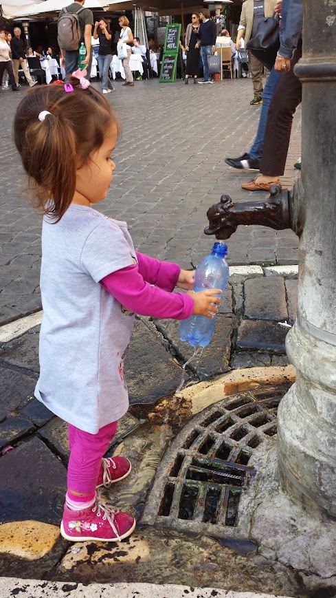 Naomi refilling her water bottle from a Nasone