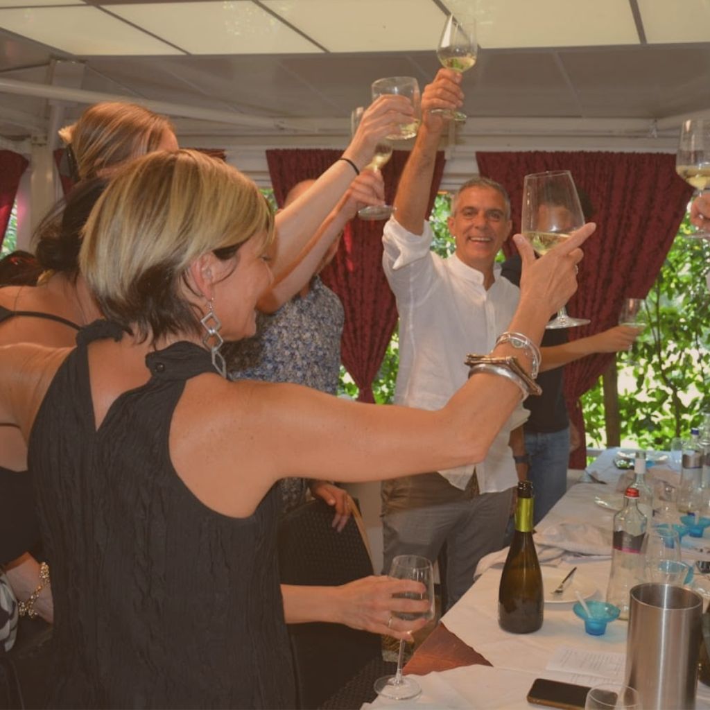 tour group toasting at dinner