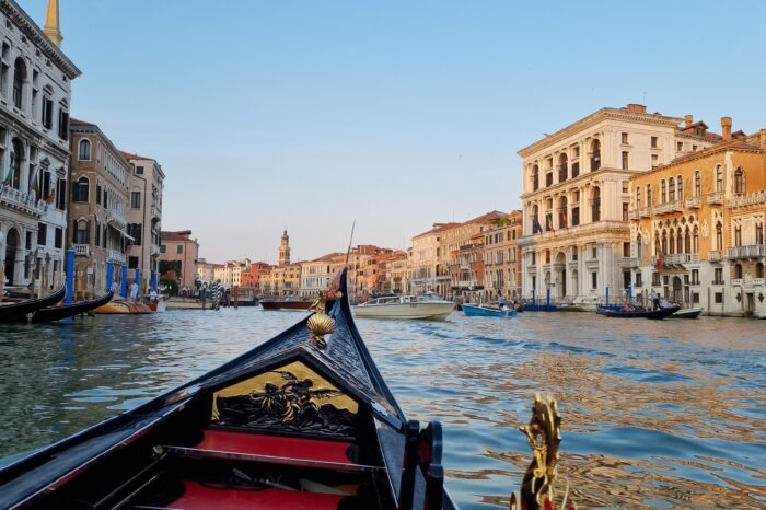 Journeying down a canal in Venice aboard a gondola