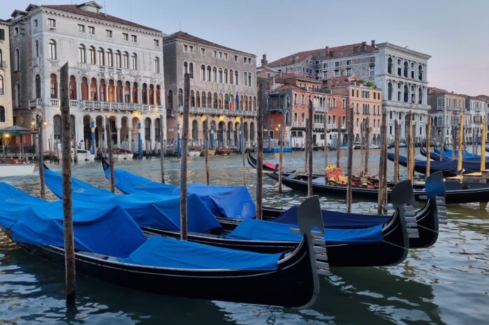 Gondolas lining Venetian canal