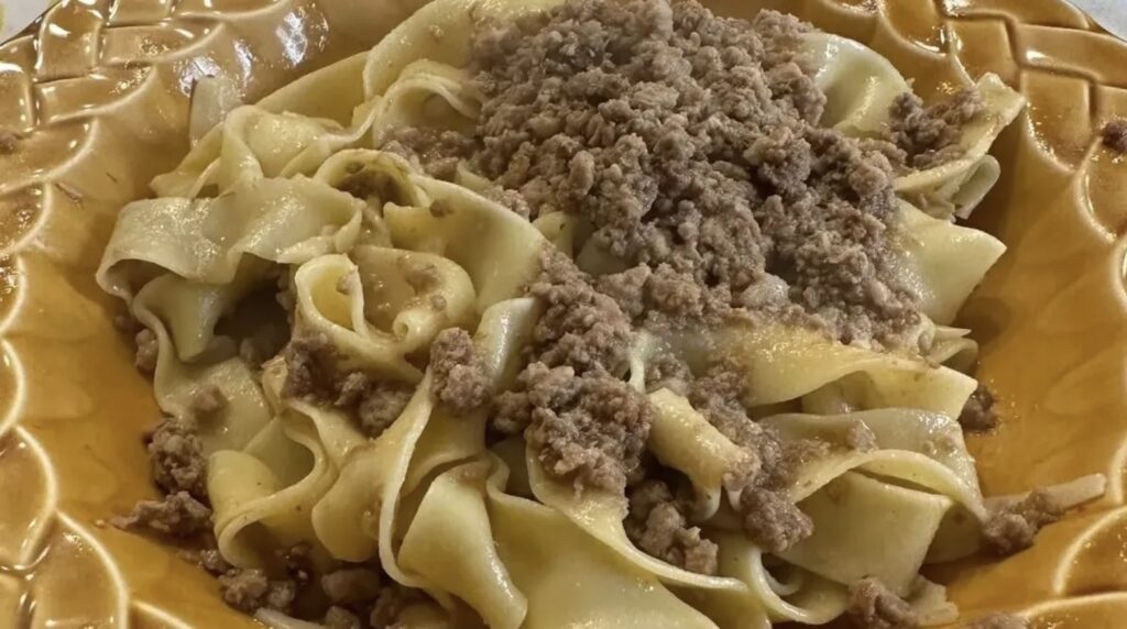 Pappardelle con Cinghiale layered on a gorgeous dish