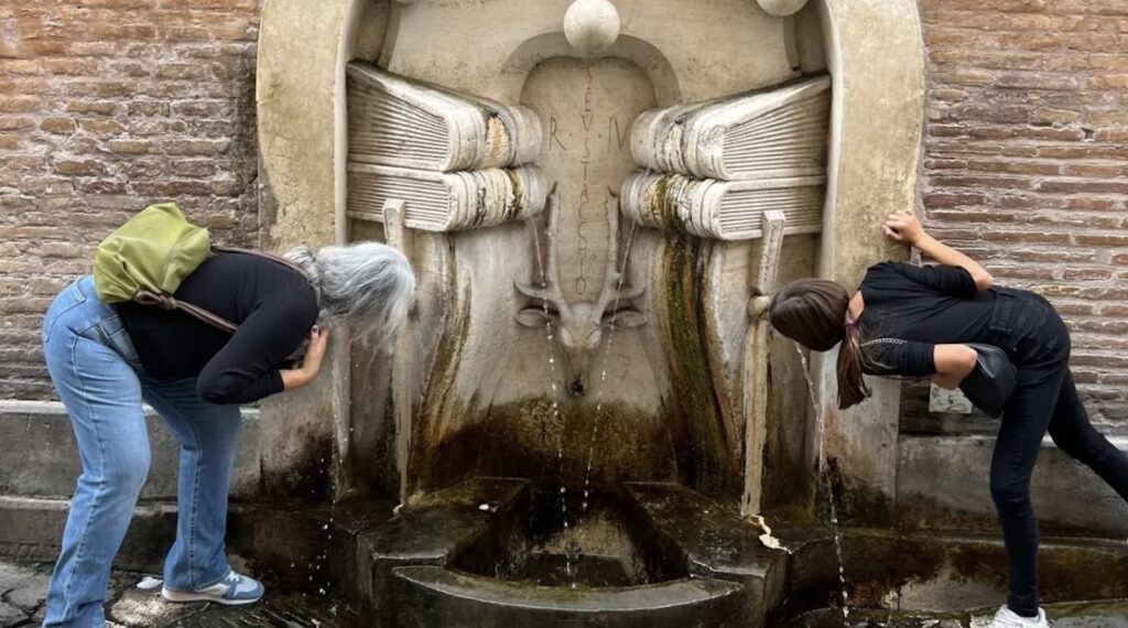 Drinking out of water fountain in rome