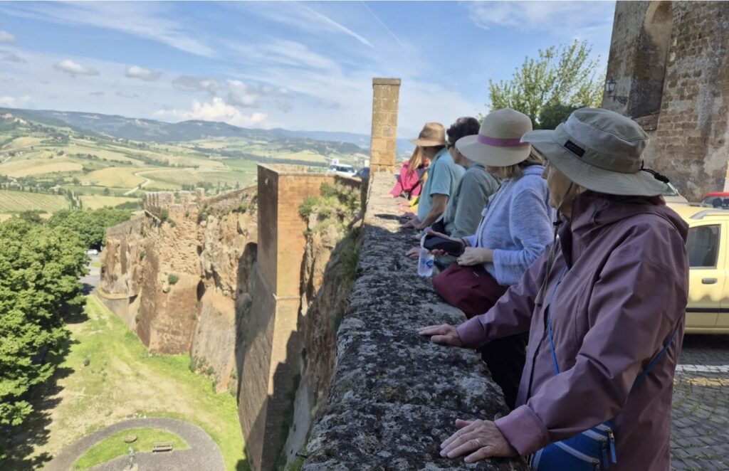 On a guided tour of orvieto - people overlooking wall