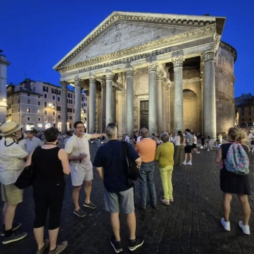 people in front of parthenon in rome at night