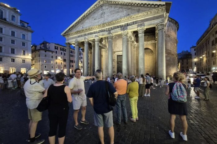 people in front of parthenon in rome at night
