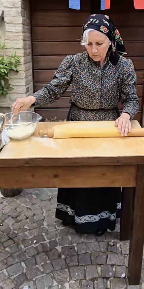 Woman making pasta in the street